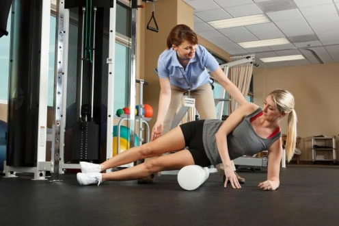 Woman Physical Therapist Instructor Helping Her Patient